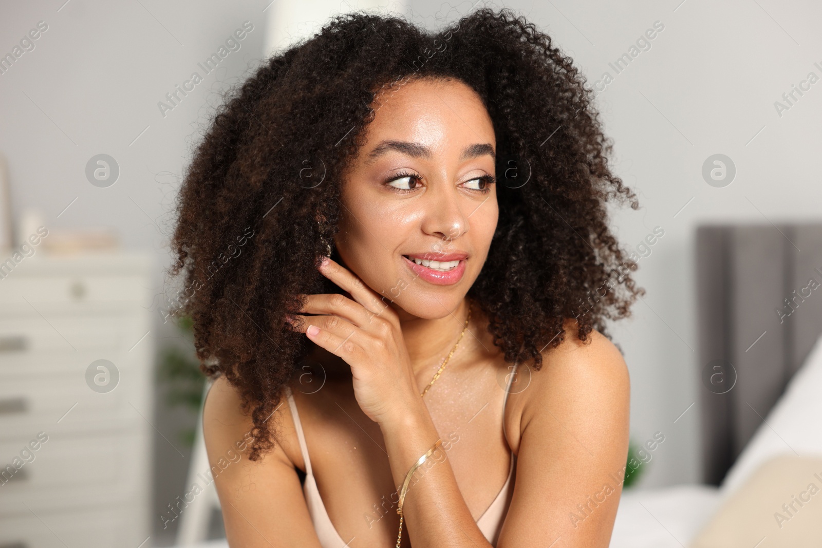 Beautiful smiling Brazilian woman with curly hair indoors Photo of Beautiful smiling Brazilian woman with curly hair indoors
