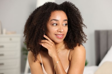 Photo of Beautiful smiling Brazilian woman with curly hair indoors
