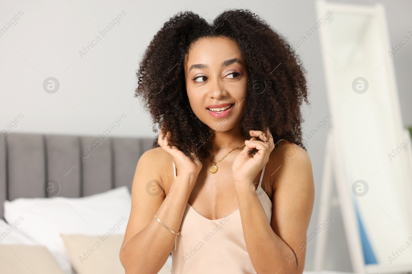 Beautiful smiling Brazilian woman with curly hair indoors Photo of Beautiful smiling Brazilian woman with curly hair indoors