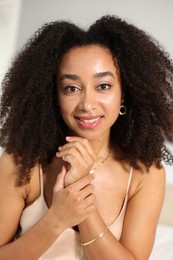 Photo of Beautiful smiling Brazilian woman with curly hair indoors