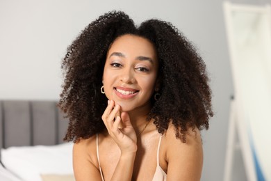 Photo of Beautiful smiling Brazilian woman with curly hair indoors