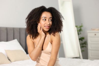 Photo of Beautiful smiling Brazilian woman with curly hair indoors
