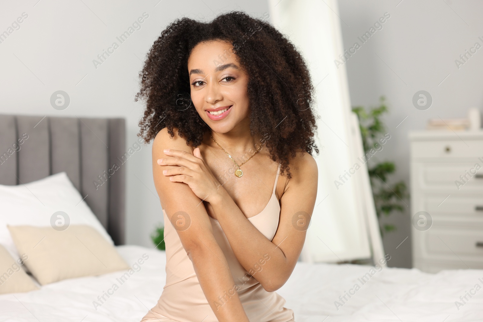 Beautiful smiling Brazilian woman with curly hair indoors Photo of Beautiful smiling Brazilian woman with curly hair indoors