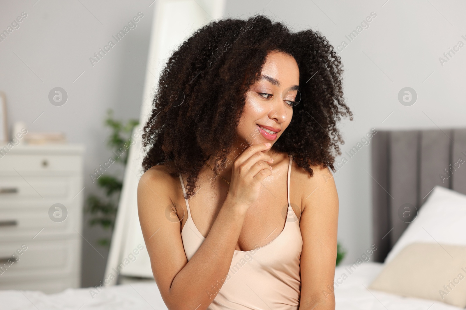 Beautiful smiling Brazilian woman with curly hair indoors Photo of Beautiful smiling Brazilian woman with curly hair indoors