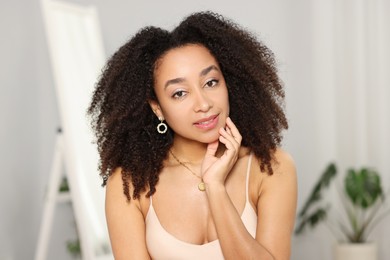 Photo of Beautiful Brazilian woman with curly hair indoors