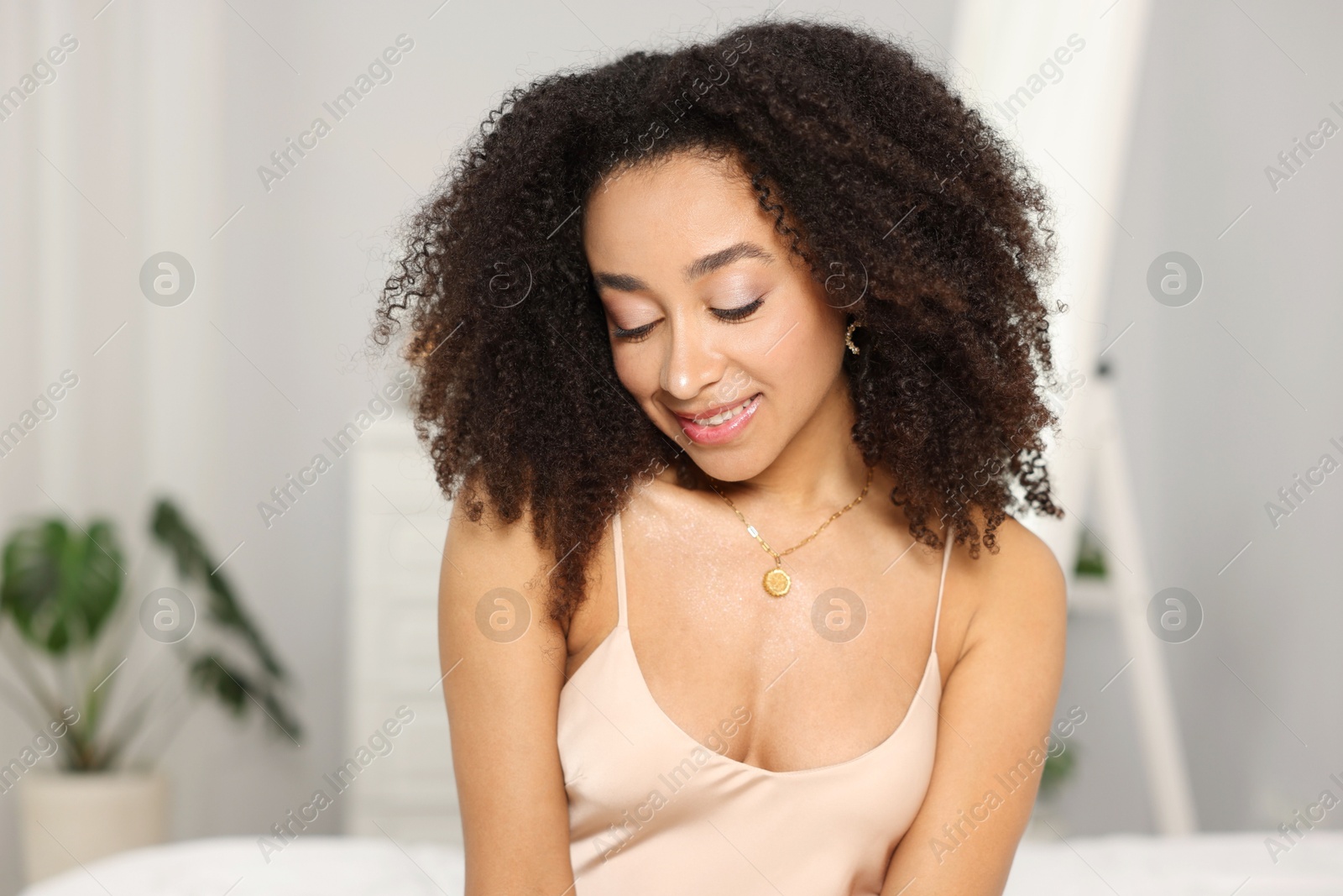 Beautiful smiling Brazilian woman with curly hair indoors Photo of Beautiful smiling Brazilian woman with curly hair indoors