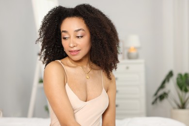 Photo of Beautiful Brazilian woman with curly hair indoors