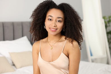 Photo of Beautiful smiling Brazilian woman with curly hair indoors