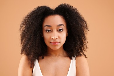 Photo of Portrait of beautiful Brazilian woman on beige background