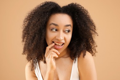 Photo of Portrait of beautiful Brazilian woman on beige background