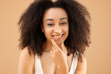 Photo of Portrait of beautiful Brazilian woman on beige background