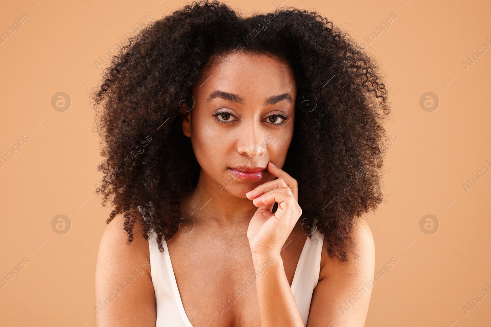 Portrait of beautiful Brazilian woman on beige background Photo of Portrait of beautiful Brazilian woman on beige background