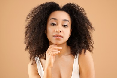 Photo of Portrait of beautiful Brazilian woman on beige background