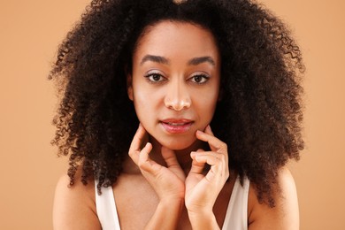 Photo of Portrait of beautiful Brazilian woman on beige background