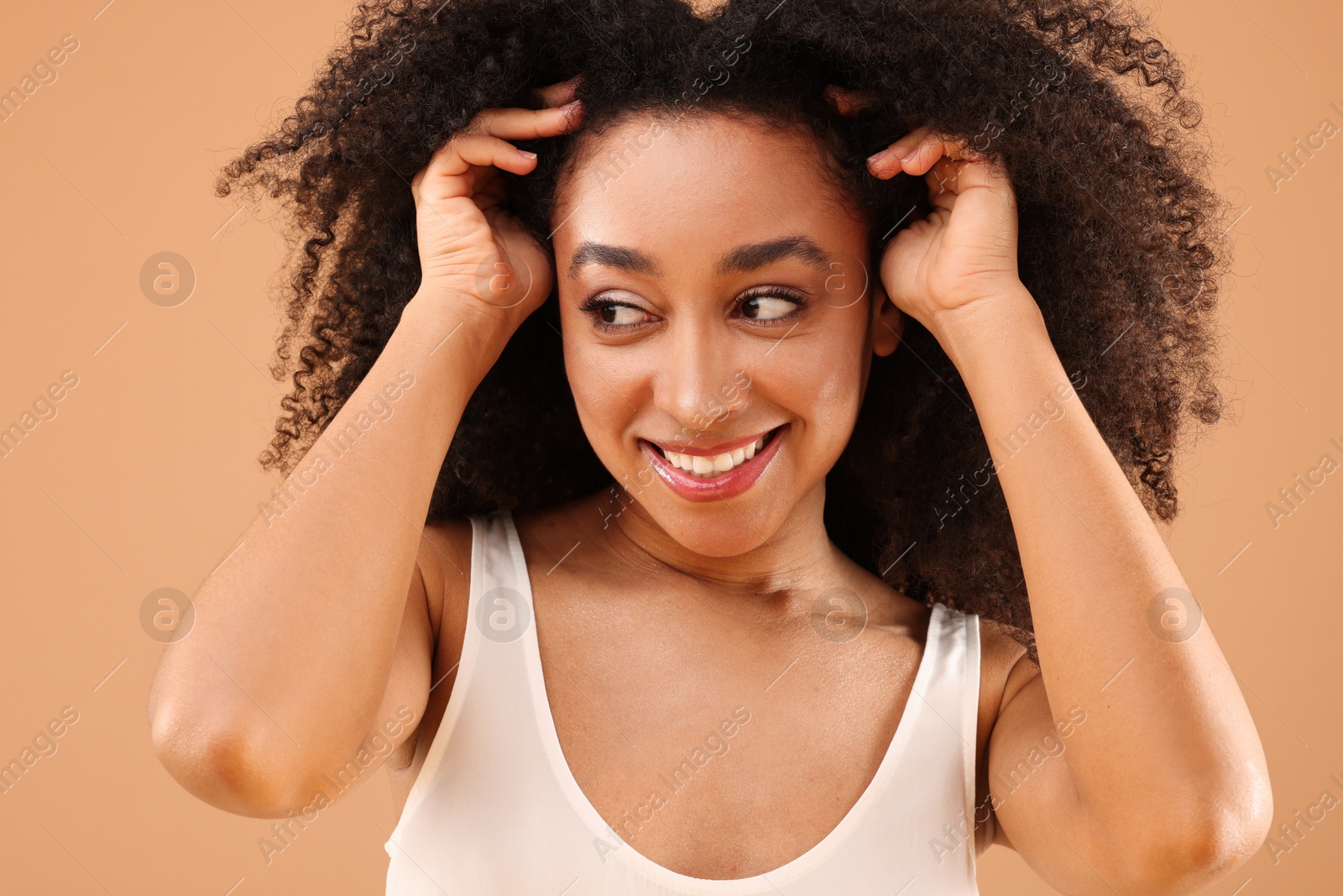 Portrait of beautiful Brazilian woman on beige background Photo of Portrait of beautiful Brazilian woman on beige background