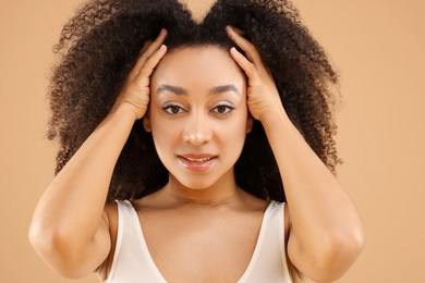 Photo of Portrait of beautiful Brazilian woman on beige background