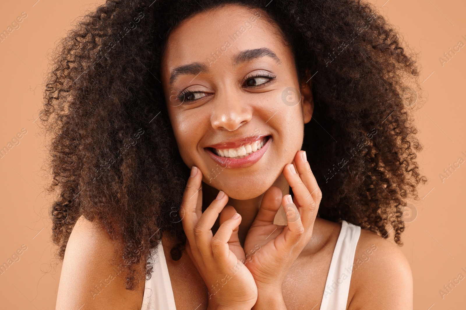 Portrait of beautiful Brazilian woman on beige background Photo of Portrait of beautiful Brazilian woman on beige background