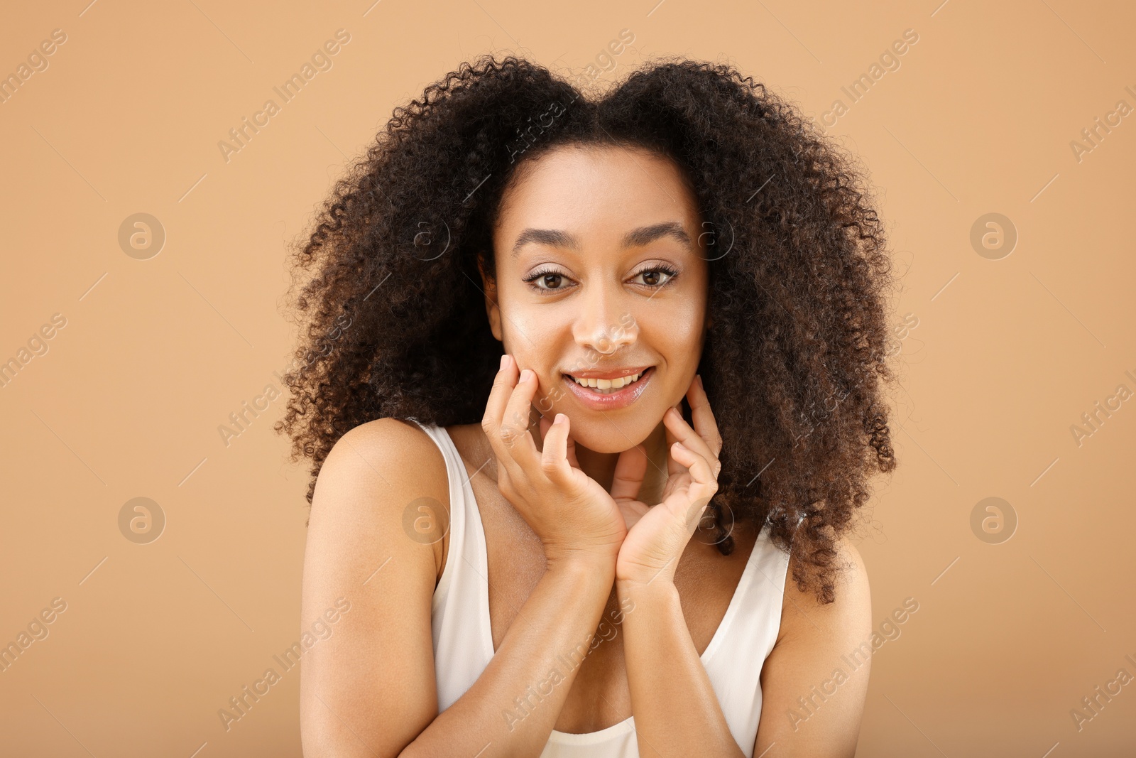 Portrait of beautiful Brazilian woman on beige background Photo of Portrait of beautiful Brazilian woman on beige background
