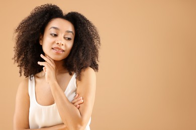 Photo of Portrait of beautiful Brazilian woman on beige background, space for text