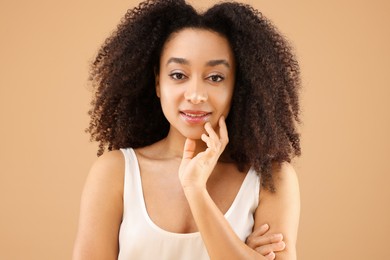 Photo of Portrait of beautiful Brazilian woman on beige background