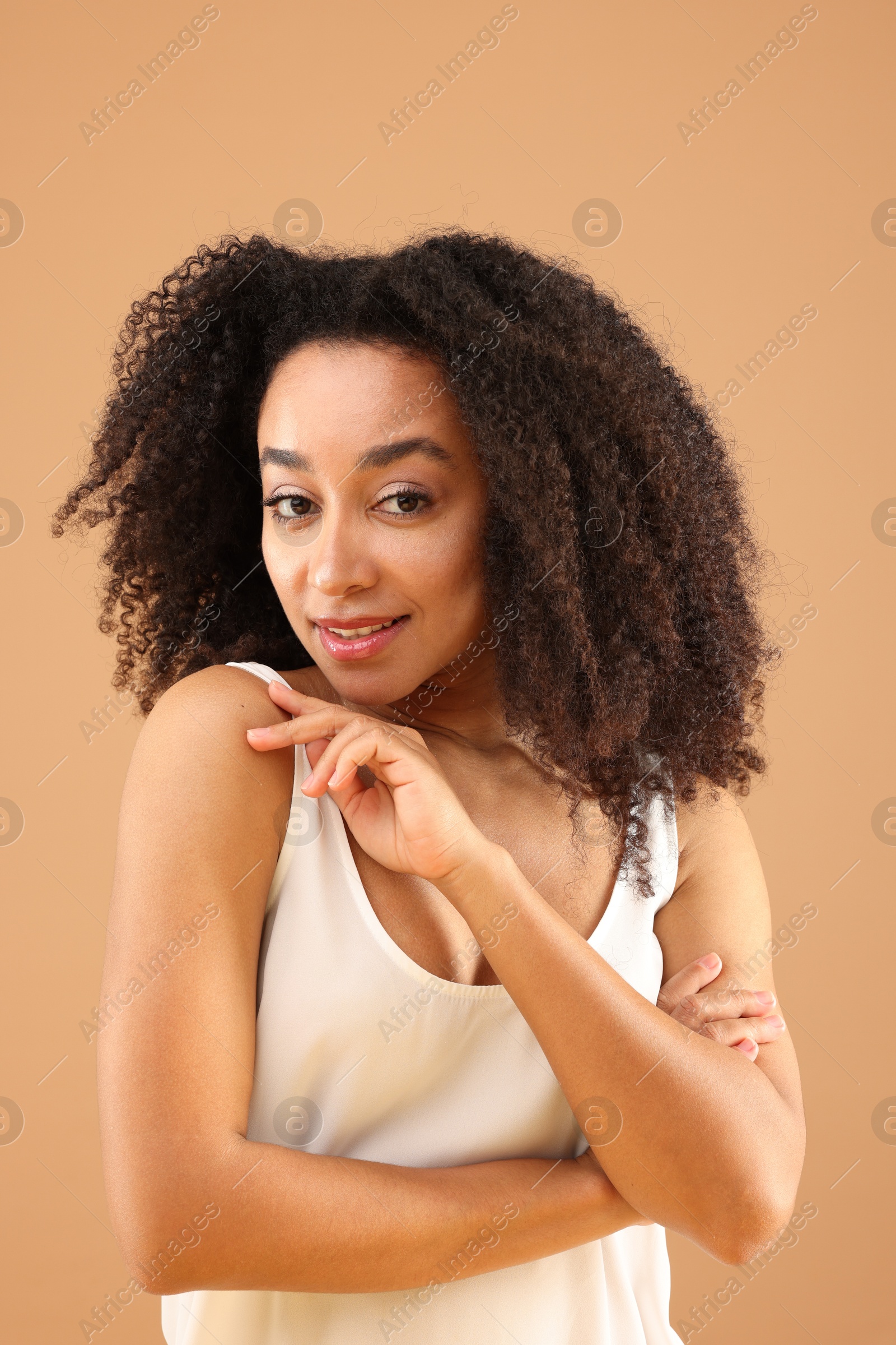 Portrait of beautiful Brazilian woman on beige background Photo of Portrait of beautiful Brazilian woman on beige background