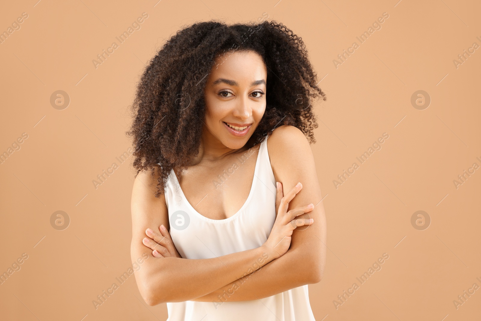 Portrait of beautiful Brazilian woman on beige background Photo of Portrait of beautiful Brazilian woman on beige background