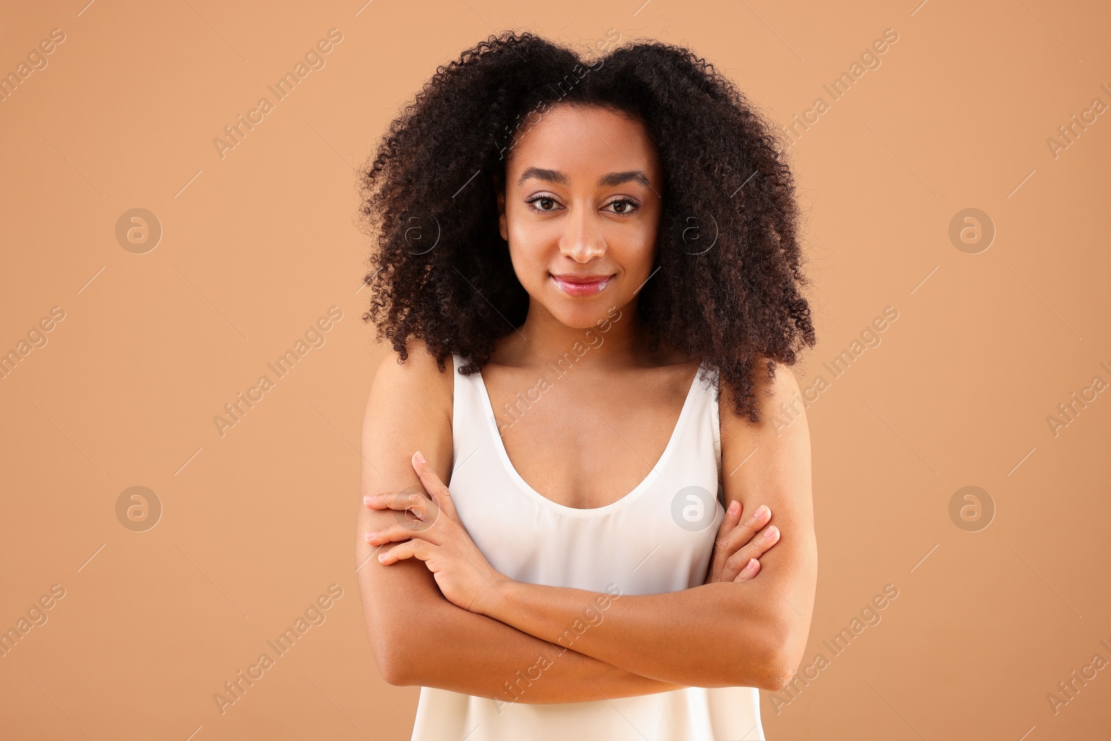 Portrait of beautiful Brazilian woman on beige background Photo of Portrait of beautiful Brazilian woman on beige background