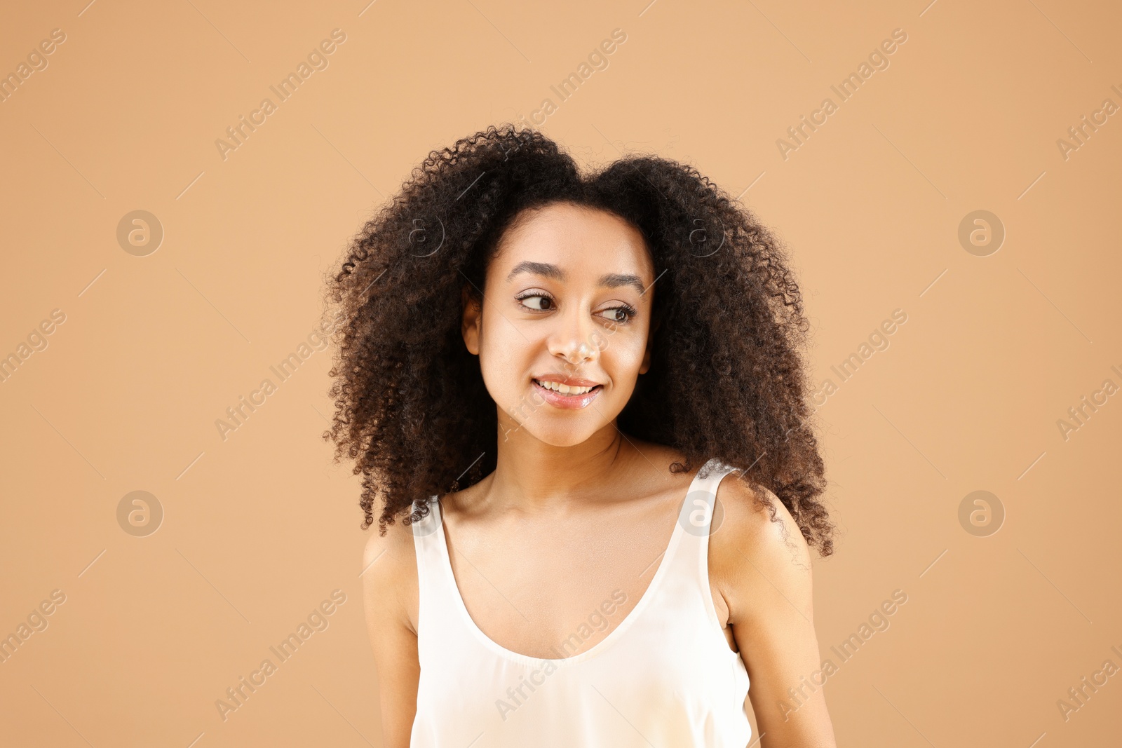 Portrait of beautiful Brazilian woman on beige background Photo of Portrait of beautiful Brazilian woman on beige background