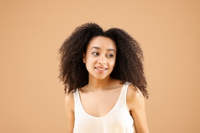 Photo of Portrait of beautiful Brazilian woman on beige background