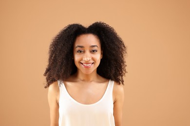 Photo of Portrait of beautiful Brazilian woman on beige background