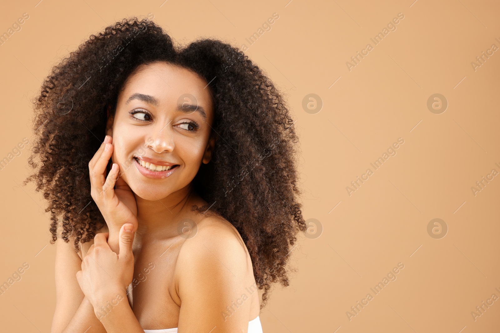 Portrait of beautiful Brazilian woman on beige background, space for text Photo of Portrait of beautiful Brazilian woman on beige background, space for text