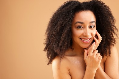 Photo of Portrait of beautiful Brazilian woman on beige background, space for text
