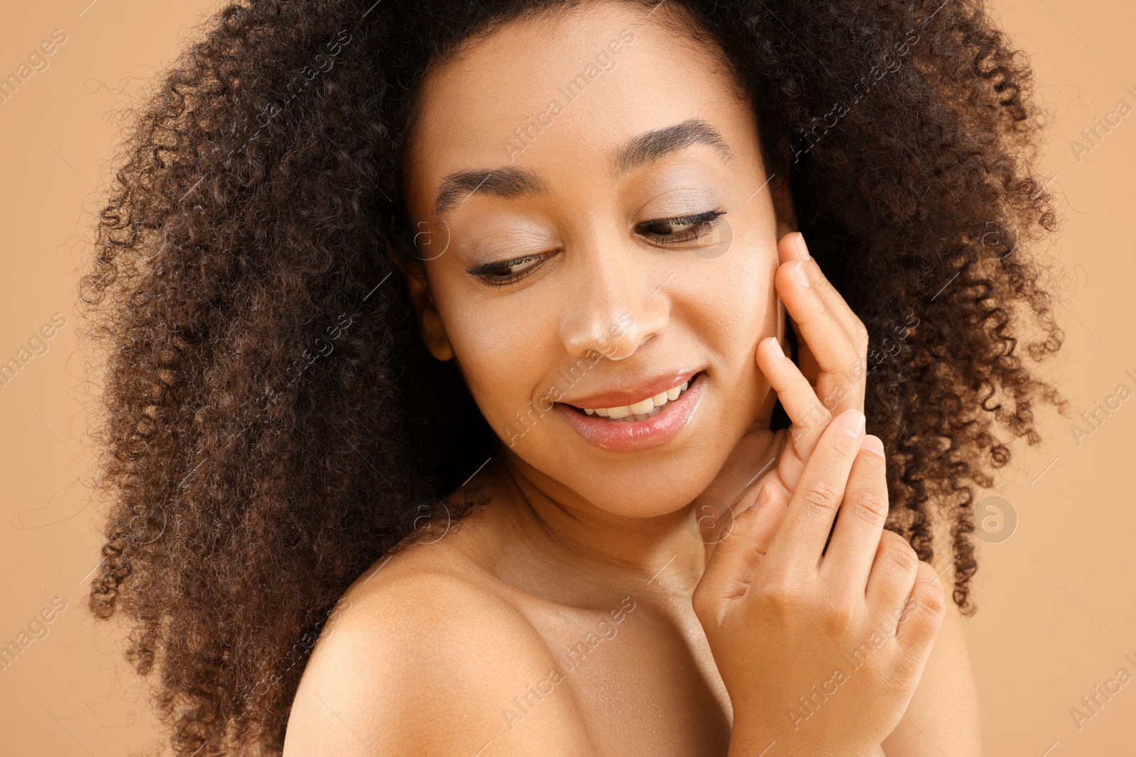 Portrait of beautiful Brazilian woman on beige background, closeup Photo of Portrait of beautiful Brazilian woman on beige background, closeup