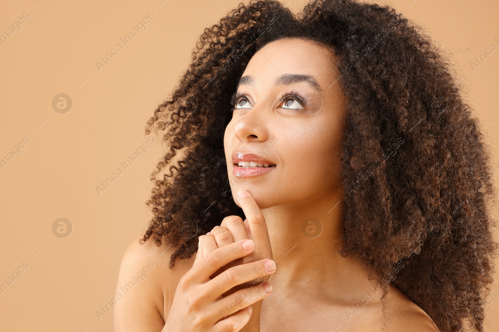 Portrait of beautiful Brazilian woman on beige background Photo of Portrait of beautiful Brazilian woman on beige background
