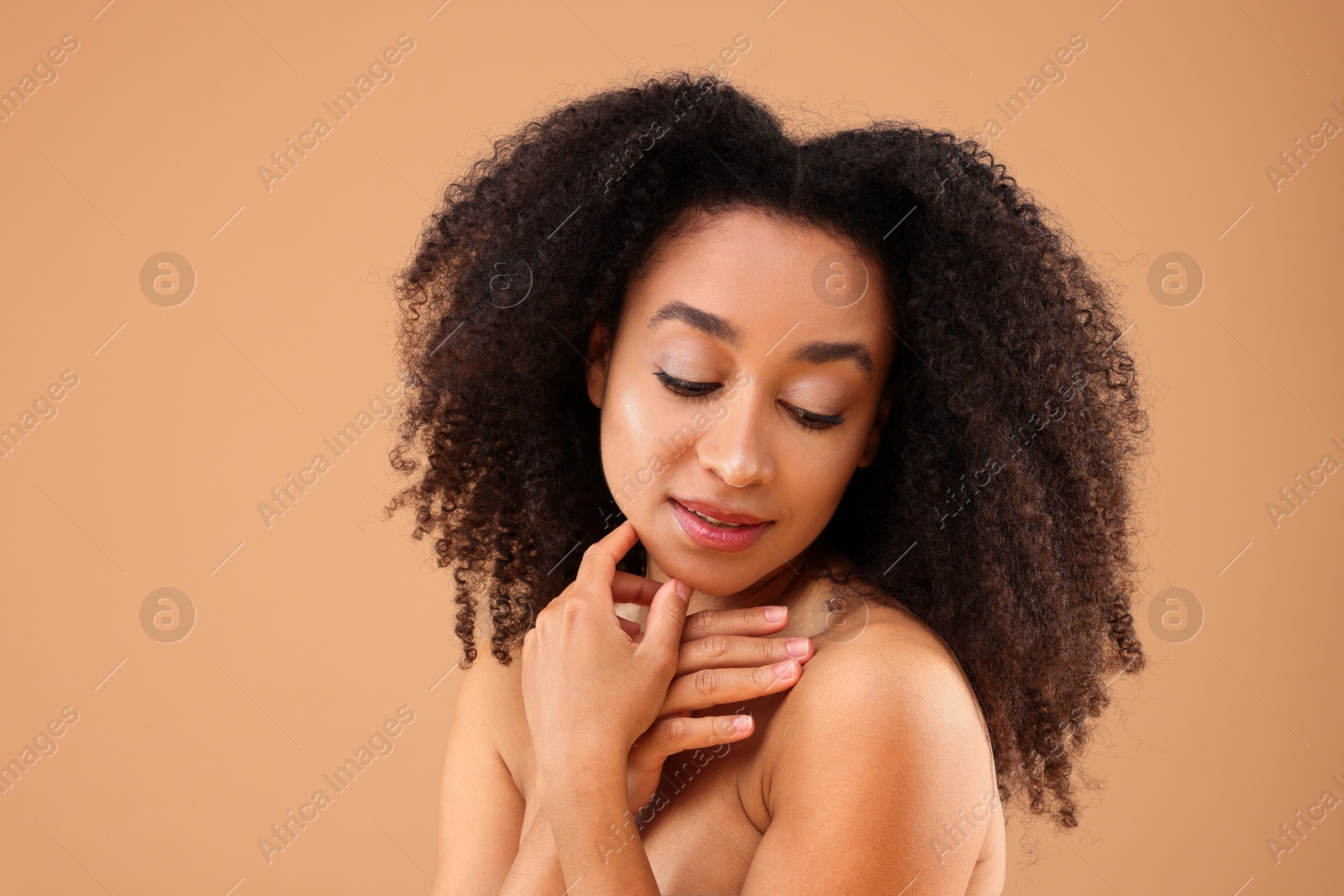 Portrait of beautiful Brazilian woman on beige background Photo of Portrait of beautiful Brazilian woman on beige background