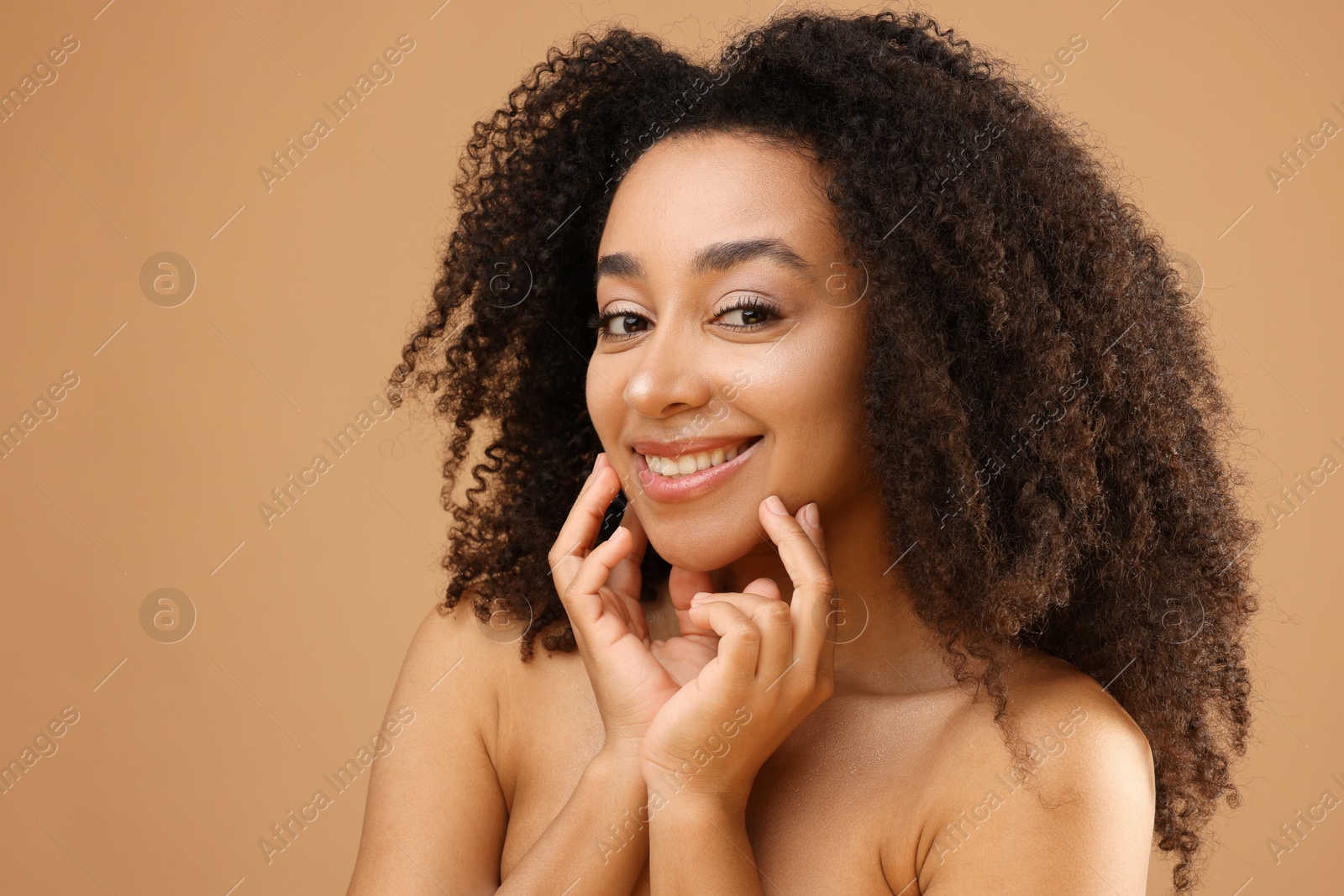 Portrait of beautiful Brazilian woman on beige background Photo of Portrait of beautiful Brazilian woman on beige background