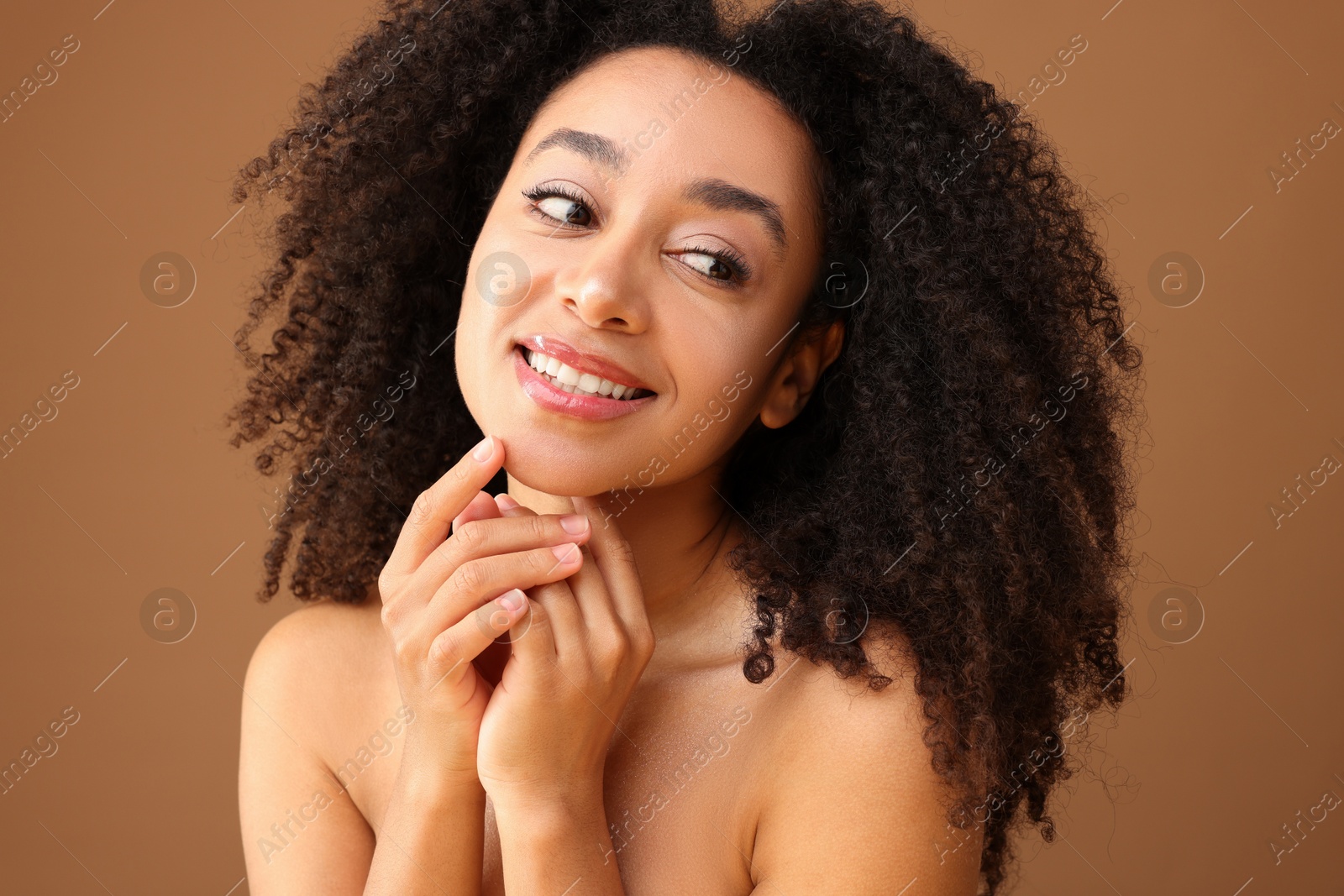 Portrait of beautiful Brazilian woman on light brown background Photo of Portrait of beautiful Brazilian woman on light brown background