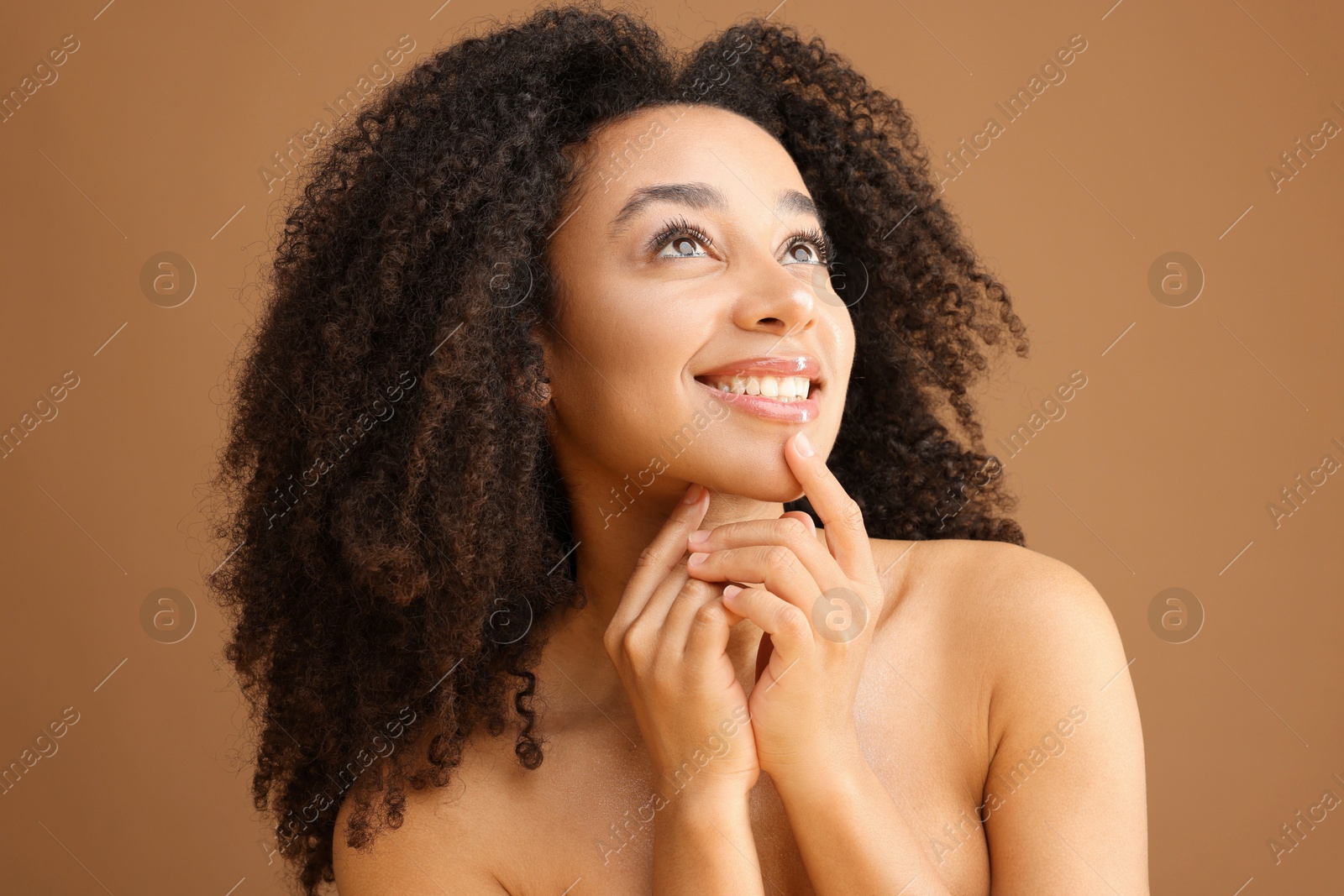 Portrait of beautiful Brazilian woman on light brown background Photo of Portrait of beautiful Brazilian woman on light brown background