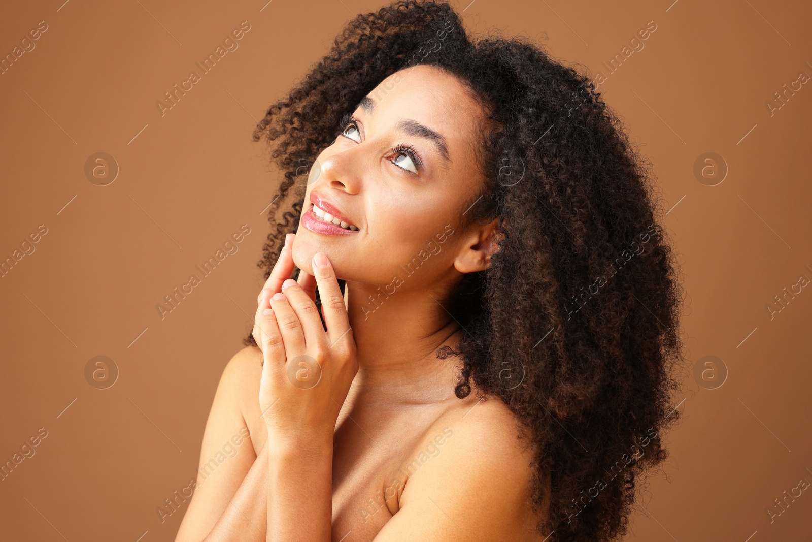 Portrait of beautiful Brazilian woman on light brown background Photo of Portrait of beautiful Brazilian woman on light brown background