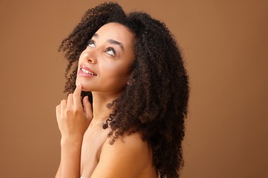 Photo of Portrait of beautiful Brazilian woman on light brown background