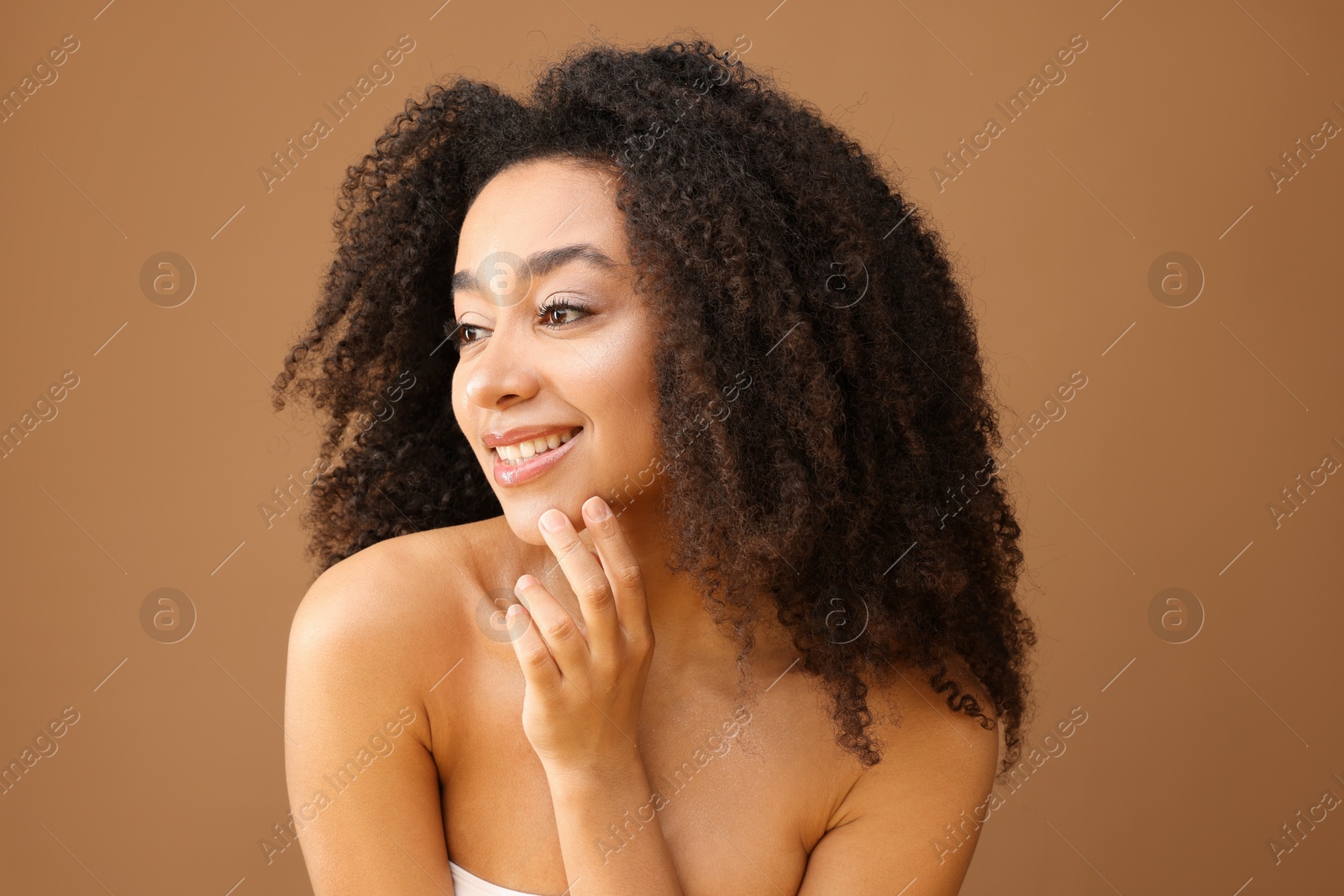 Portrait of beautiful Brazilian woman on light brown background Photo of Portrait of beautiful Brazilian woman on light brown background