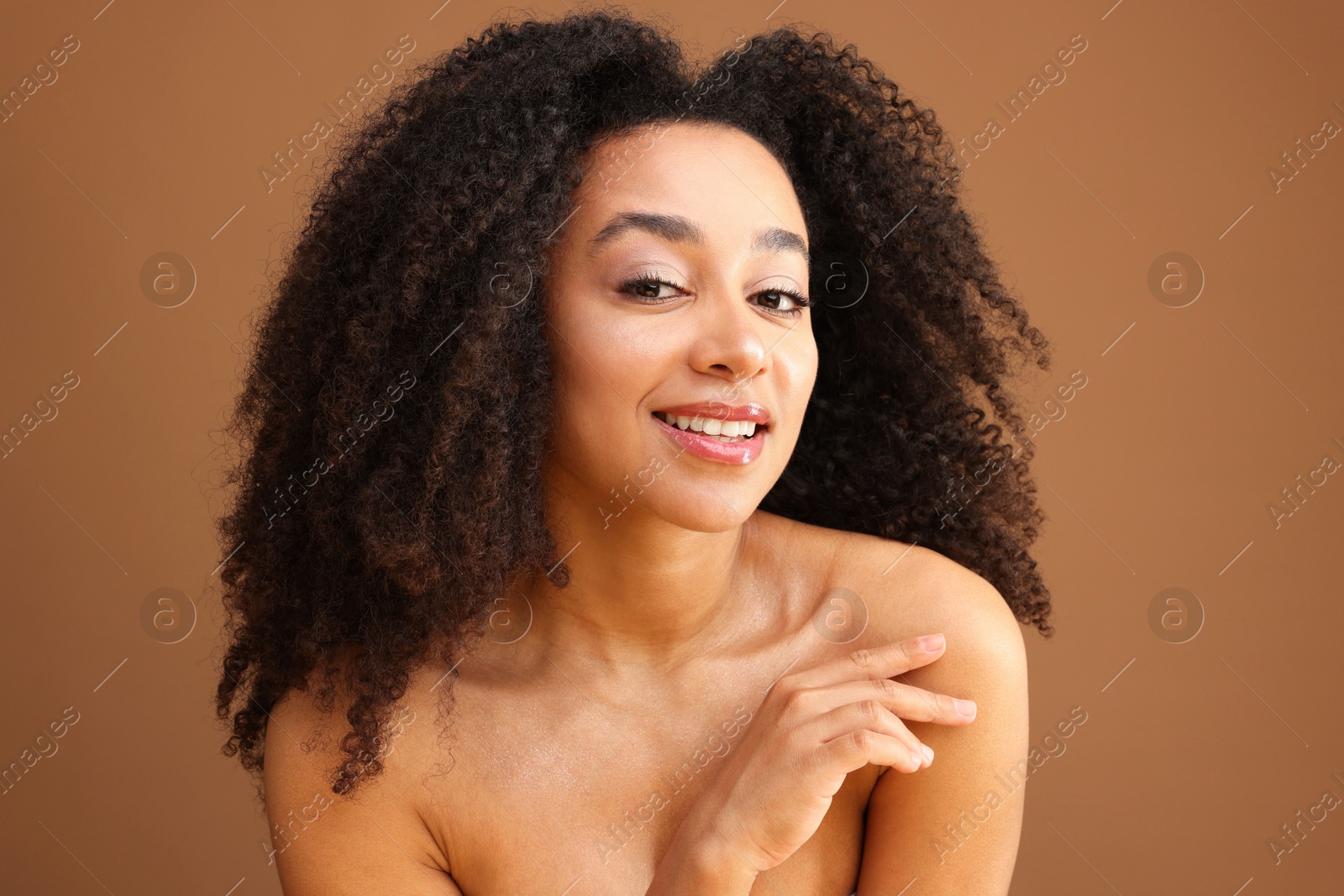 Portrait of beautiful Brazilian woman on light brown background Photo of Portrait of beautiful Brazilian woman on light brown background