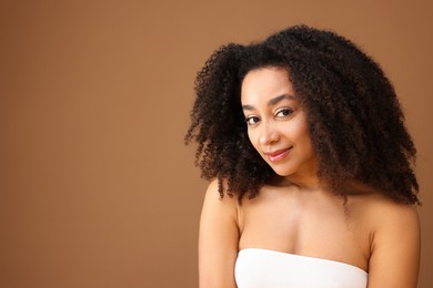 Photo of Portrait of beautiful Brazilian woman on light brown background, space for text