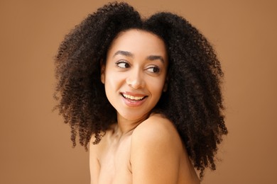 Photo of Portrait of beautiful Brazilian woman on light brown background
