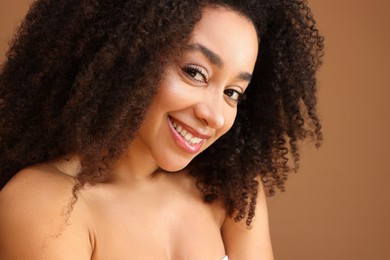 Photo of Portrait of beautiful Brazilian woman on light brown background, closeup