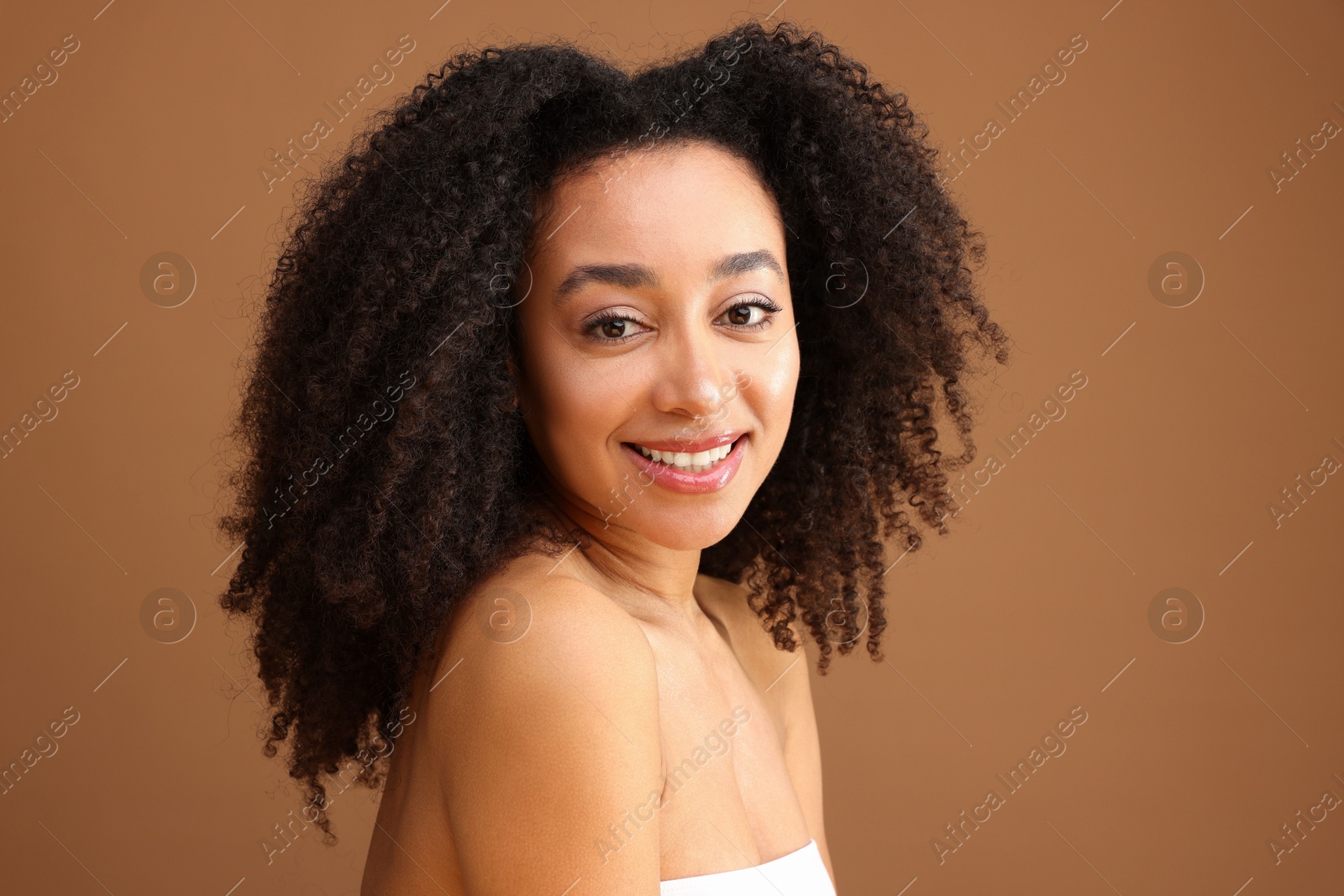 Portrait of beautiful Brazilian woman on light brown background Photo of Portrait of beautiful Brazilian woman on light brown background