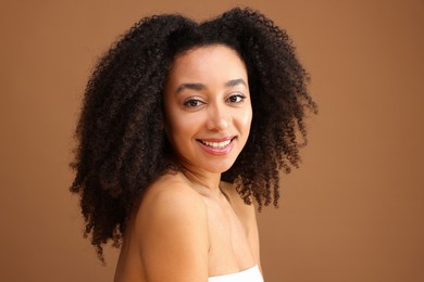 Photo of Portrait of beautiful Brazilian woman on light brown background