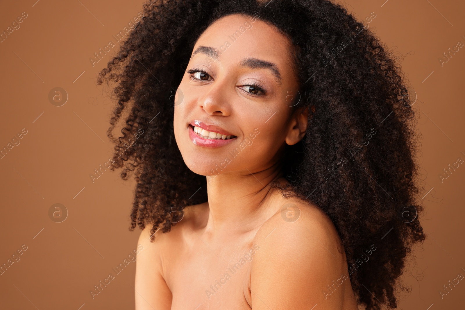 Portrait of beautiful Brazilian woman on light brown background Photo of Portrait of beautiful Brazilian woman on light brown background