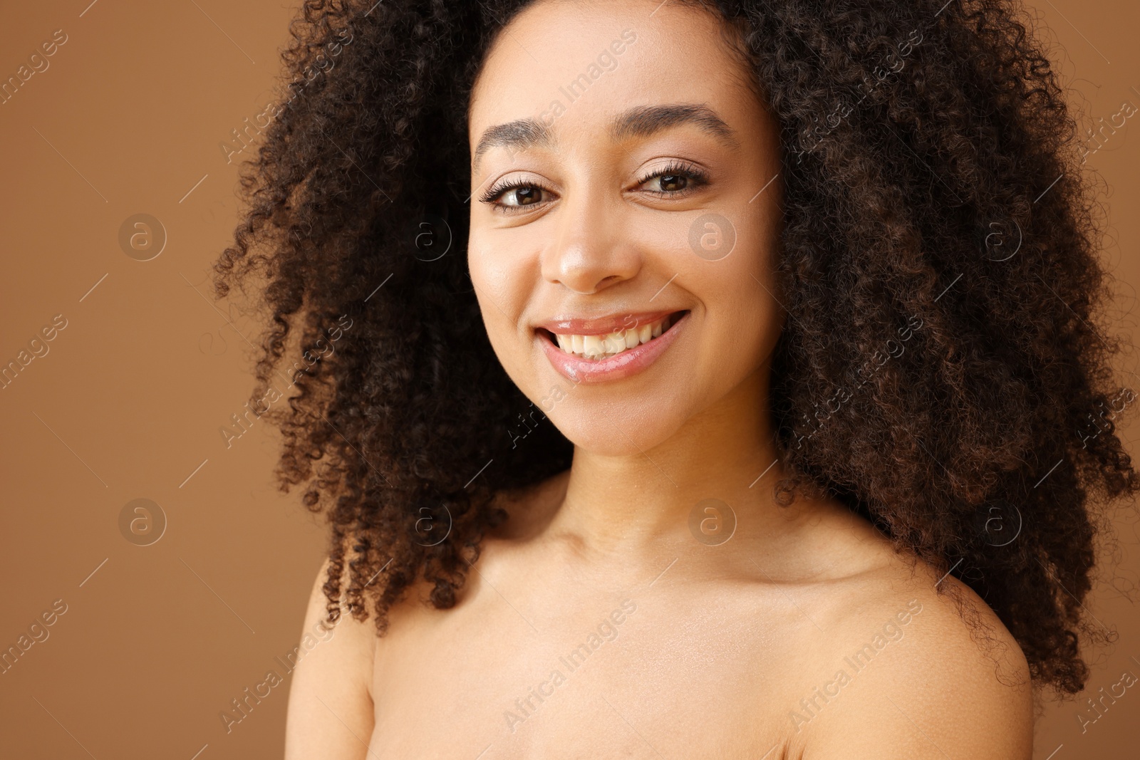 Portrait of beautiful Brazilian woman on light brown background, closeup Photo of Portrait of beautiful Brazilian woman on light brown background, closeup