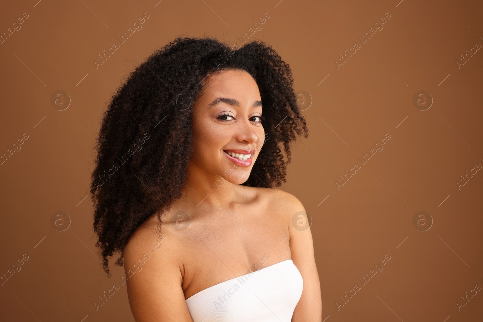 Portrait of beautiful Brazilian woman on light brown background Photo of Portrait of beautiful Brazilian woman on light brown background